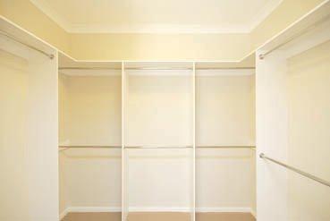 Walk In Wardrobe with multiple Garment Compartments with chrome hanging rails