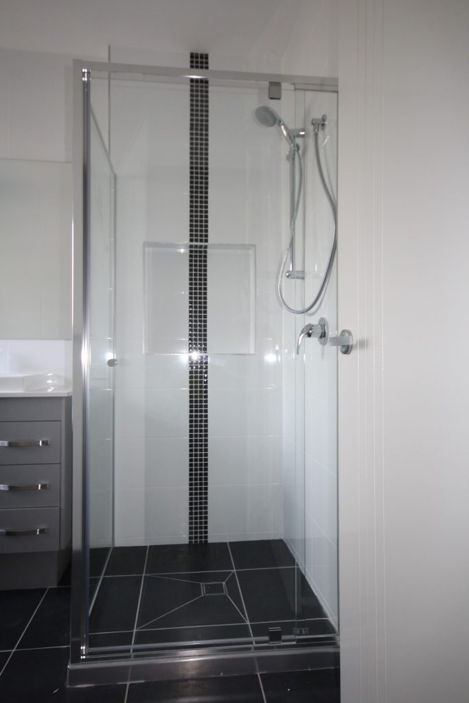 Semi frameless vogue showerscreen, polished silver framing and hinges.