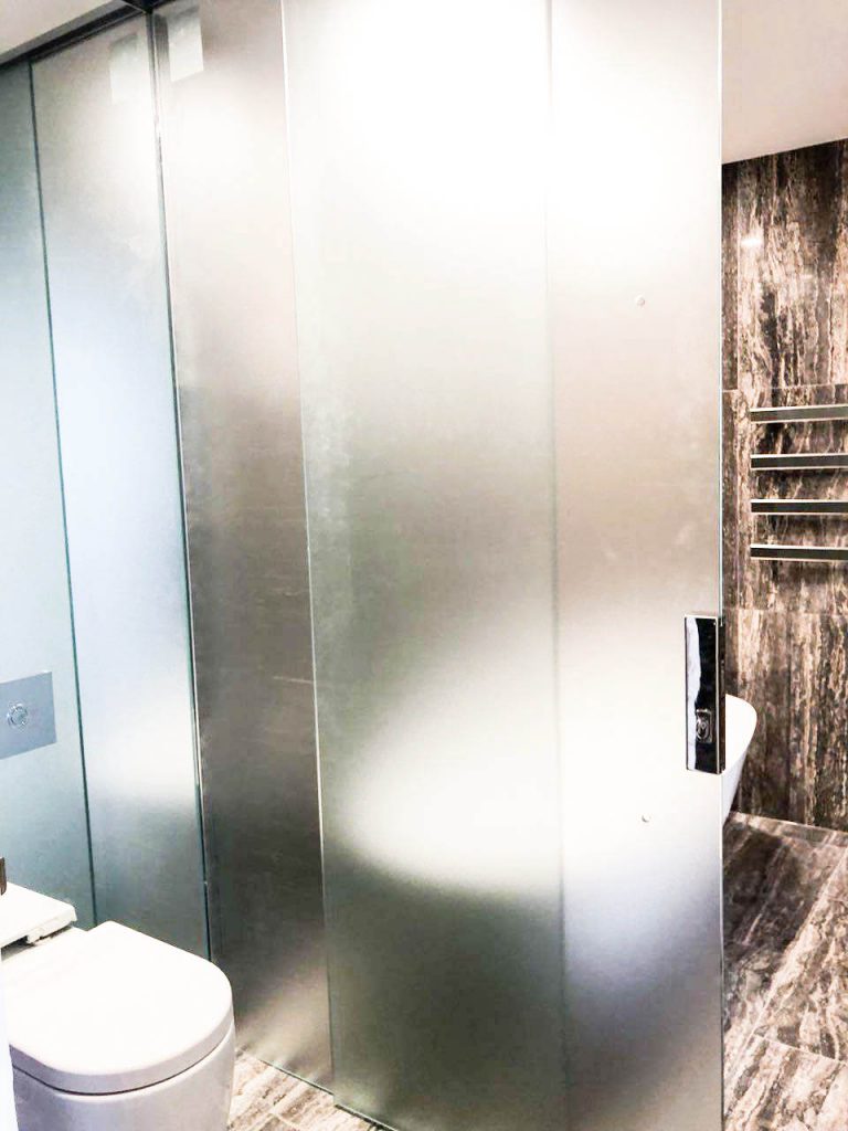 Luxury bathroom with Acid Etched Frameless Shower Screen and silver polished hinges