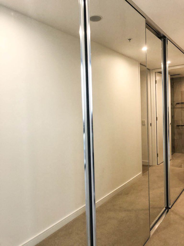 Frameless Built-in Mirrorline Wardrobe Doors in the Hallway with Silver Aluminium Track