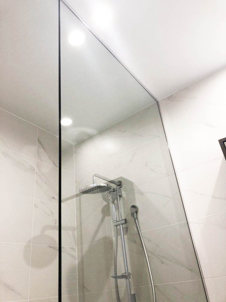 Frameless Panel in white bathroom
