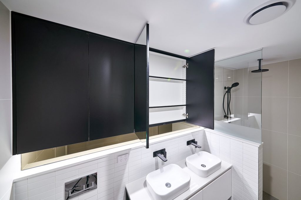 Matt Black Shaving Cabinets with a Frameless Shower Screen Panel including a Privacy Strip