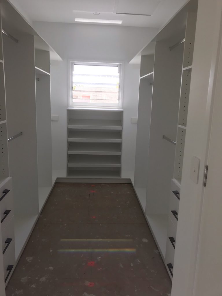 Built-In Wardrobe - White Board Shelving, Bank of Drawers, Chrome Hanging Rods & a Shoe Cupboard
