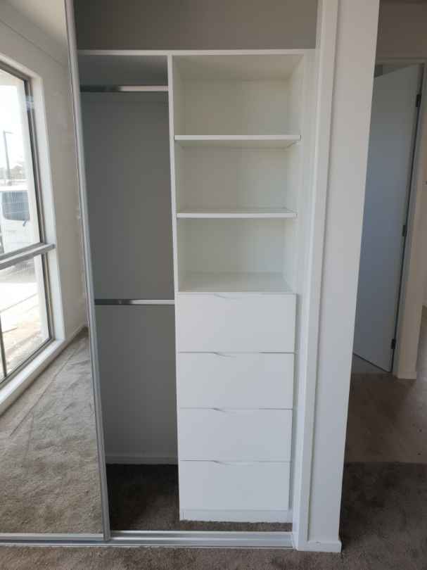 Standard White Board Shelving with Chrome Hanging Rods, Bank of Drawers & Framed Mirror Robe Doors