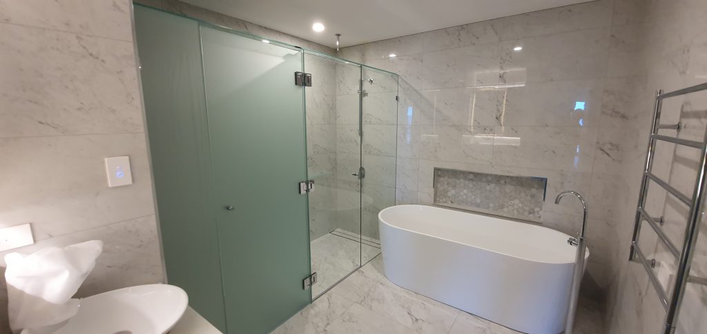 Frameless T-Screen for Shower & Toilet Area; LHS Panels are Acid Etched Glass, RHS Panels are Clear Glass, with Polished Silver Hinges