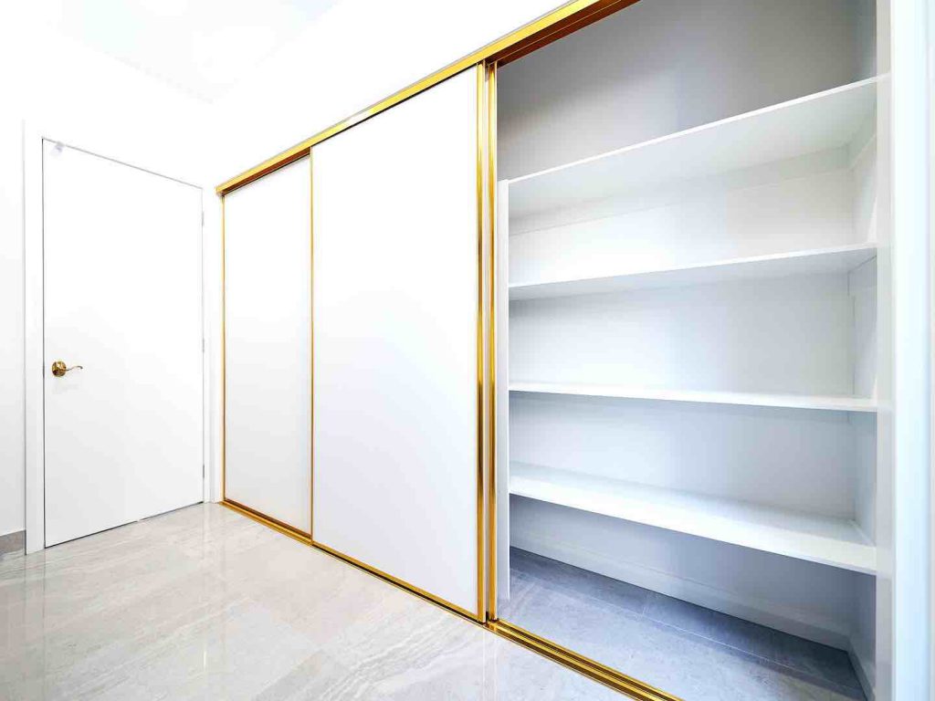 Framed Wardrobe Door in White glass insert wardrobe shelving in three sliding panels