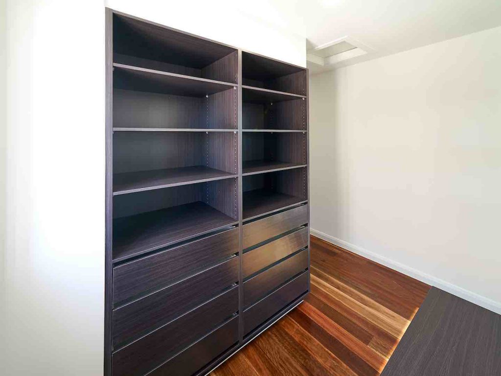 Empire Oak wardrobe shelving with multiple shelves and handleless drawers