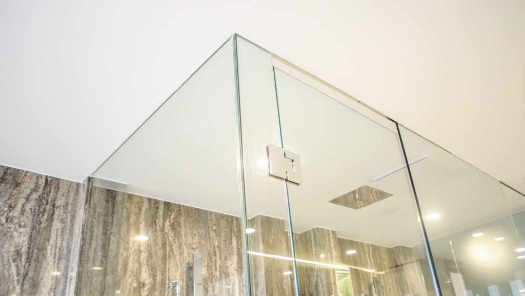 Frameless hinged shower screen on elegant bathroom