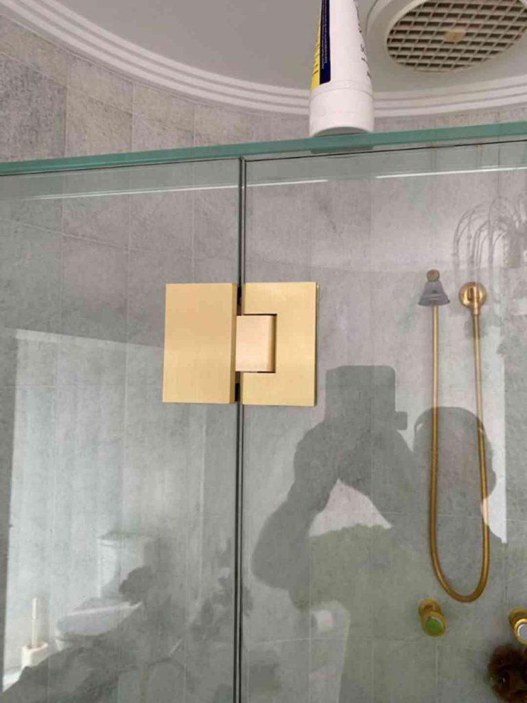 Frameless shower screen with luxurious gold polished hinges and accessories