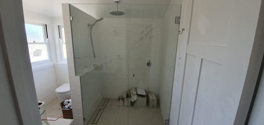Frameless Shower Screen with dogleg panel in new bathroom being constructed